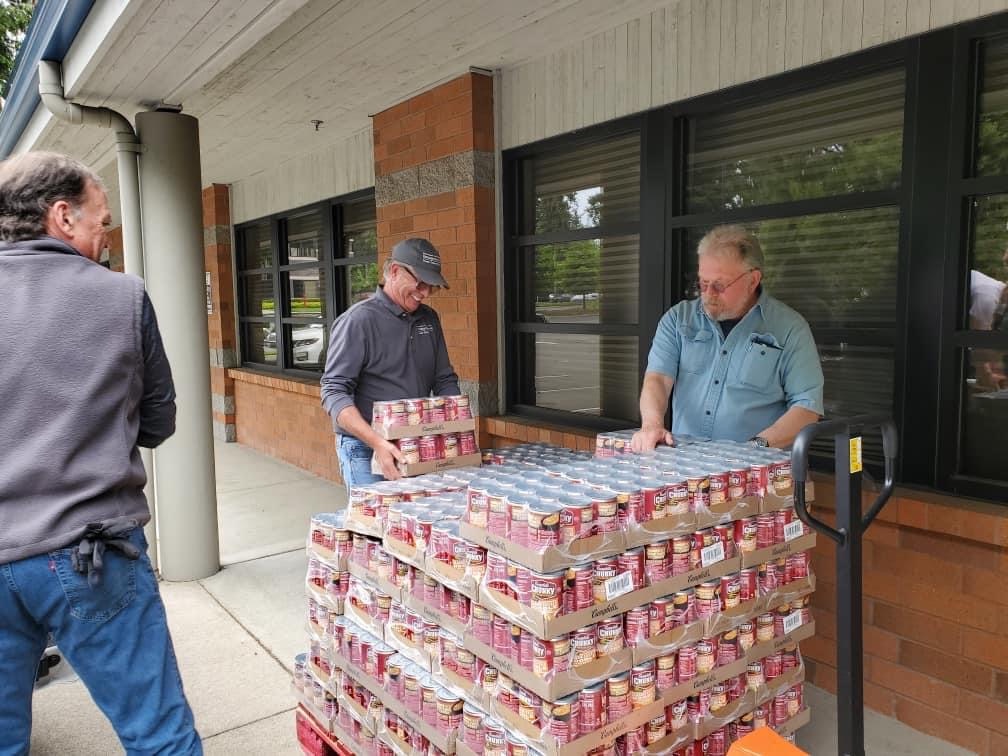 Volunteers with All Kids Win with a Pallet of canned food