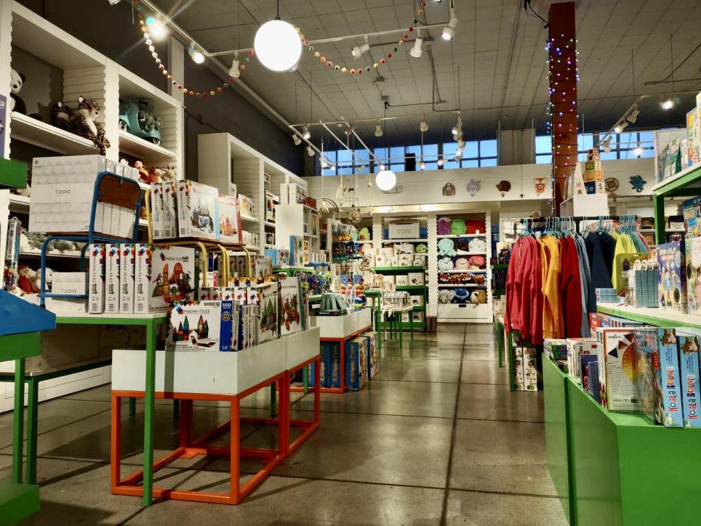 The Inside of Captain Little toy store in Olympia, white shelves full of toys