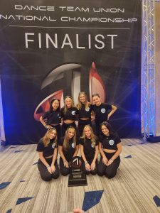 Olympia High School dance team with their seventh place trophy at Nationals