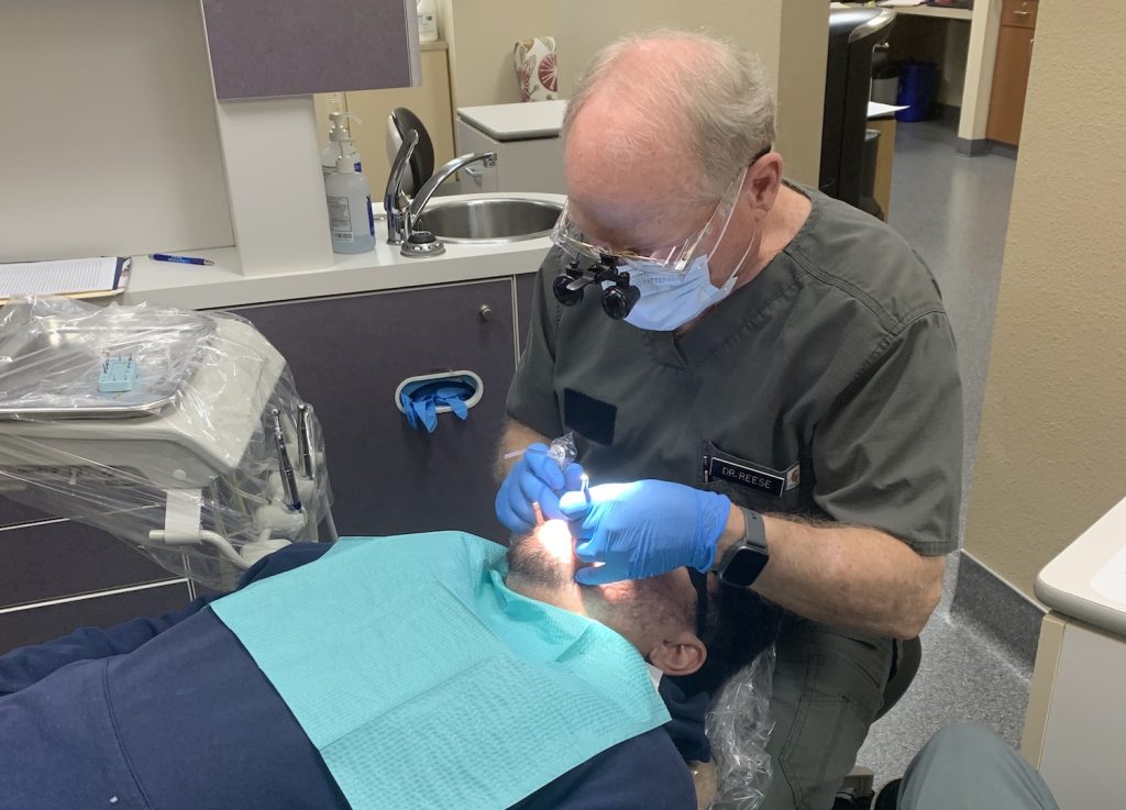 Person having his teeth looked at by a dentist