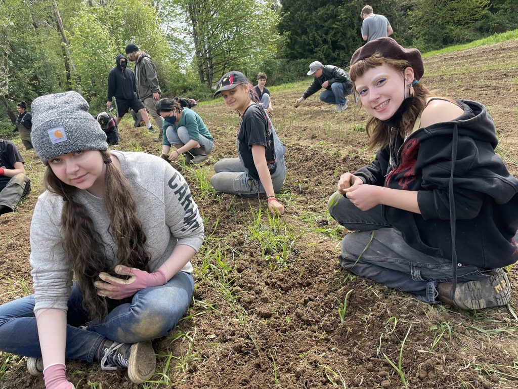 group of people working in the GRuB garden