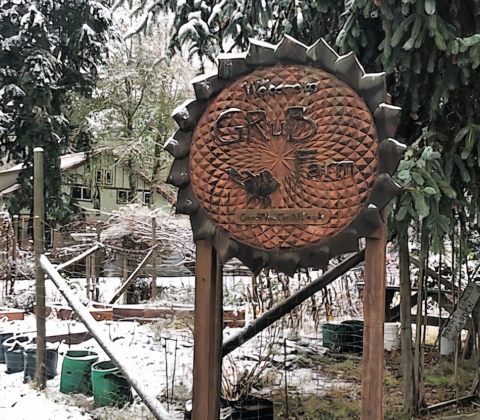 GRuB wooden sign during a snowfall