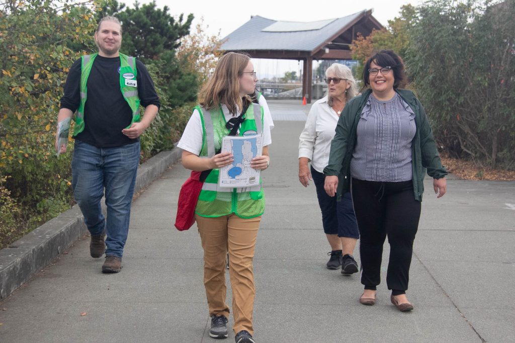 three people with a tour guide leading them on a Puget Sound  Estuarium family-friendly walking tours 