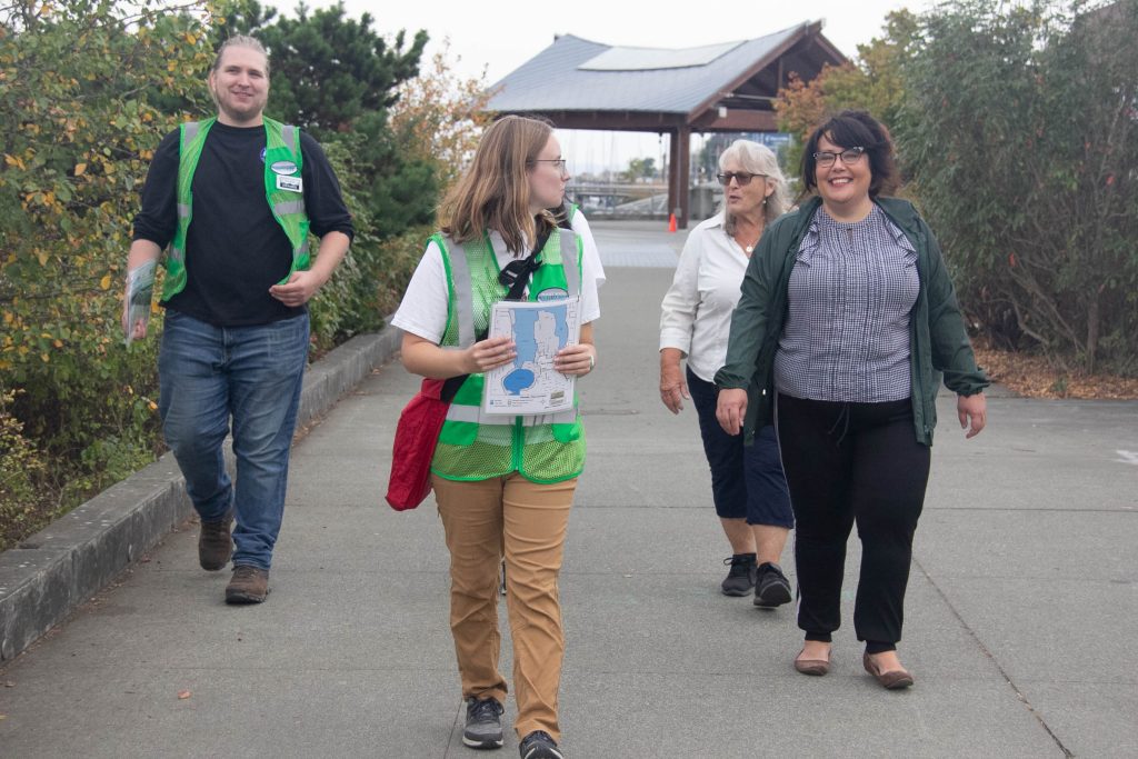 three people with a tour guide leading them on a Puget Sound Estuarium family-friendly walking tours