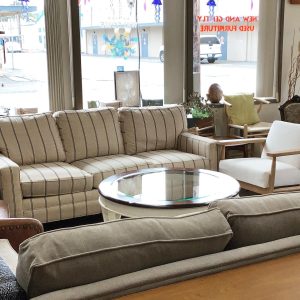white striped couch and a grey couch with a glass coffee table at South Sound Furniture in Olympia