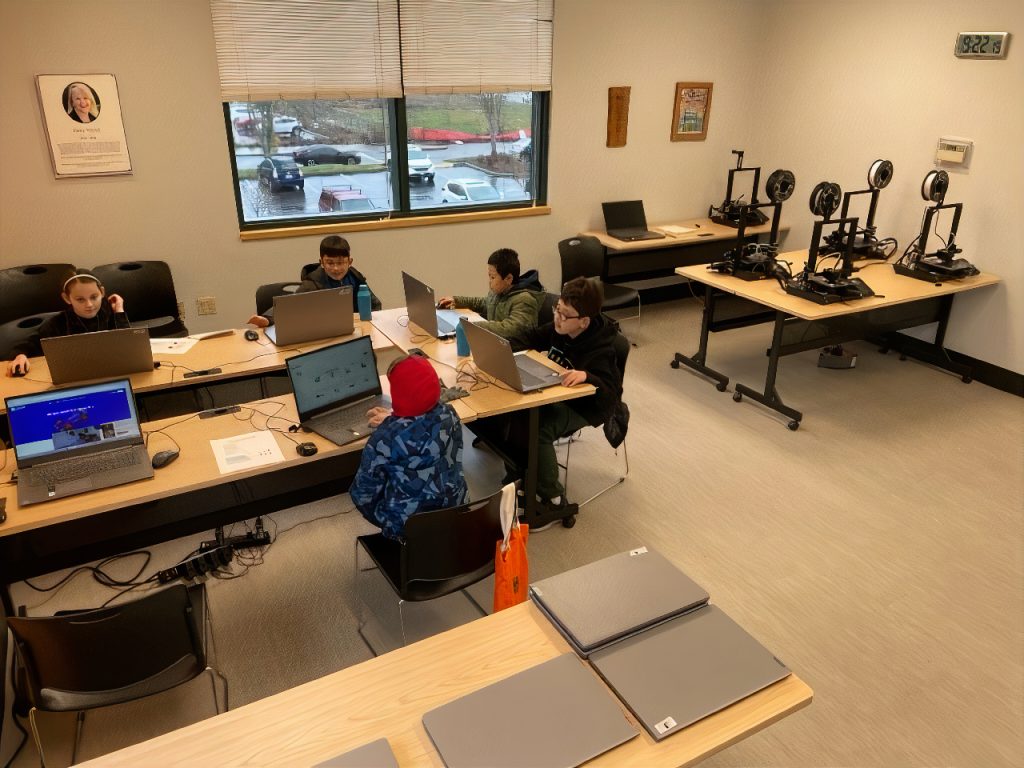 kids in a classroom with a 3D printer