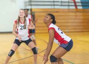 two girls playing volleyball