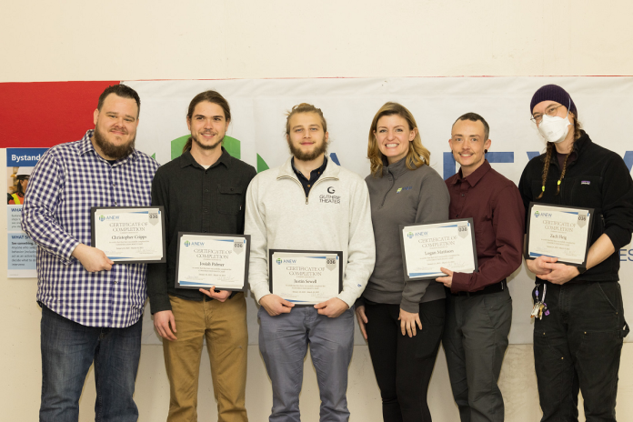 Graduates and their ANEW instructor, Amber McGinnis standing with their certificates