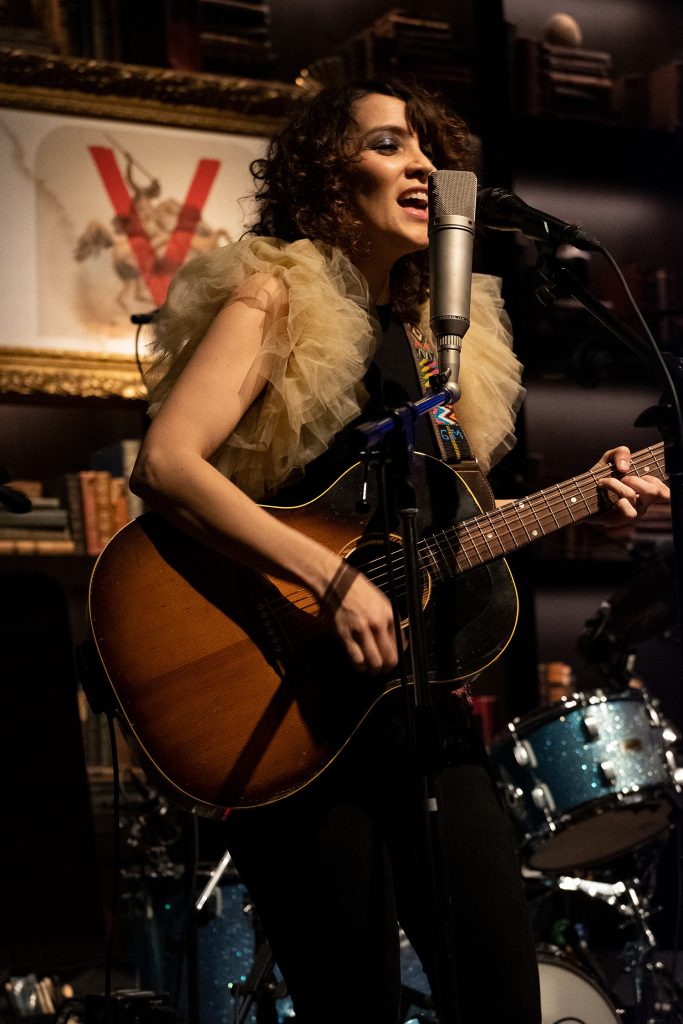 Gaby Moreno playing the guitar and singing on stage