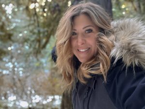 Writer Jess Caldwell outside in the forest in the Olympic Peninsula