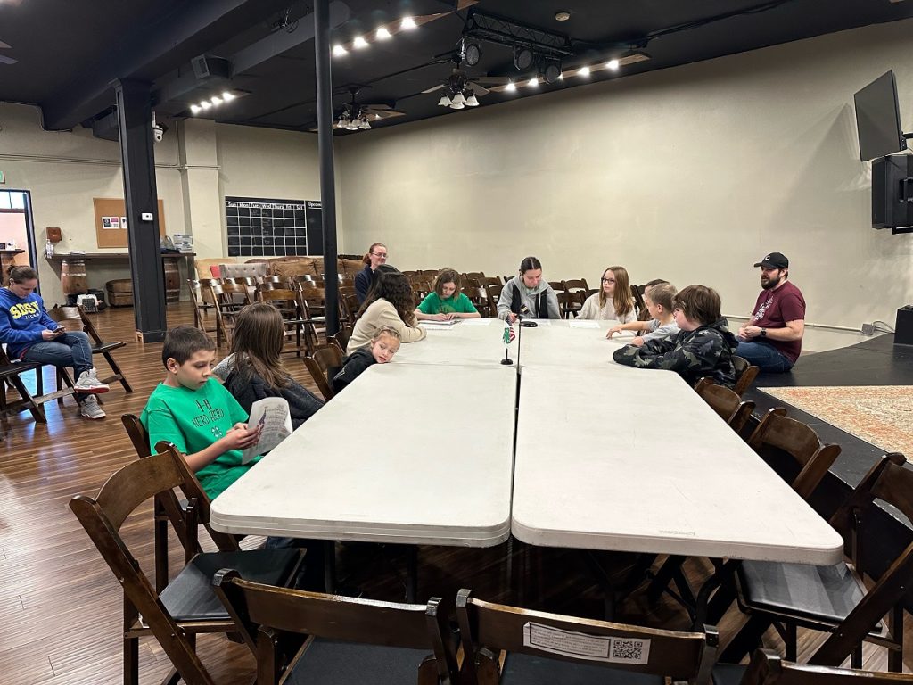 Yelm Nerd Herd 4-H club members sitting at a large folding table