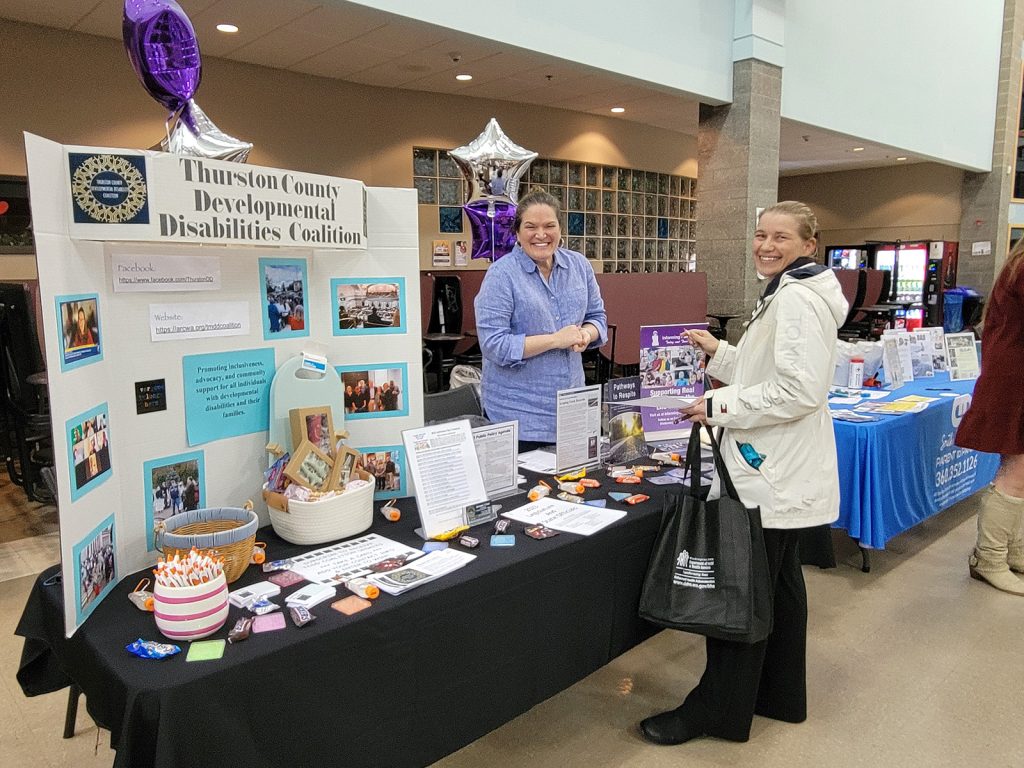 The Thurston County Developmental Disabilities Coalition booth with people at it at the Yelm Community Resources Fair