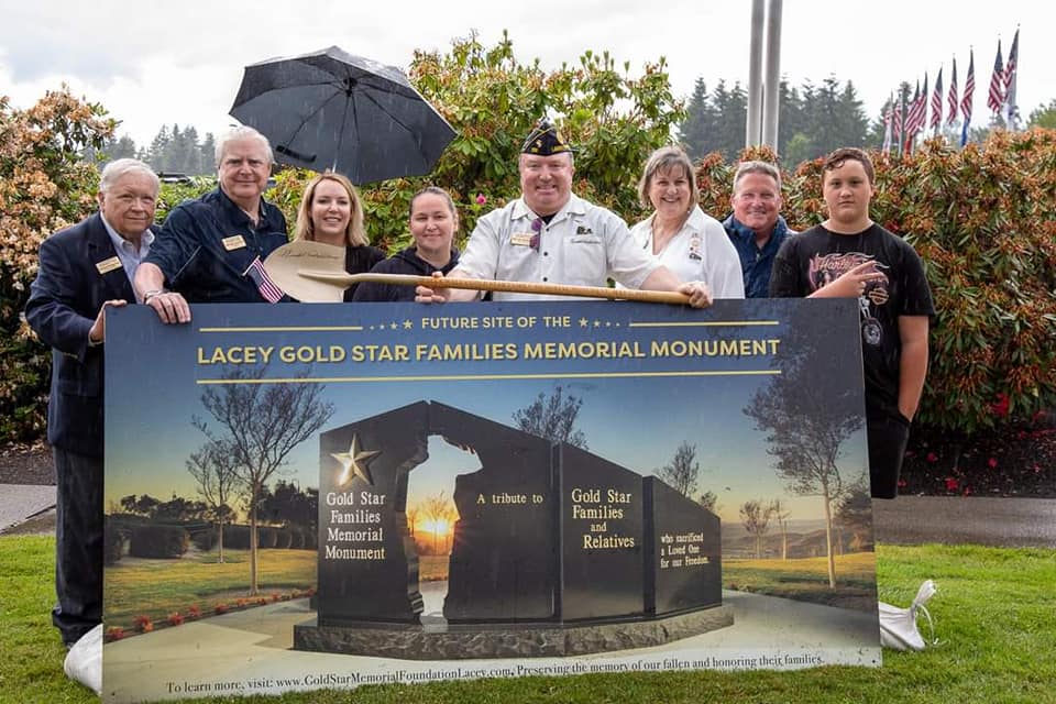 group Gold Star Memorial Foundation volunteers and organizers in behind a photo of the future Gold Star Memorial in Lacey