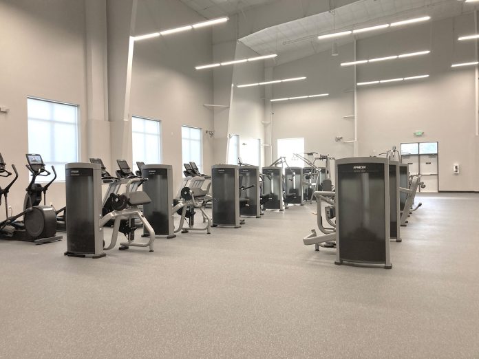Steamboat Tennis & Athletic Club exercise room with rows of exercise bikes, ellipticals, treadmills, etc.