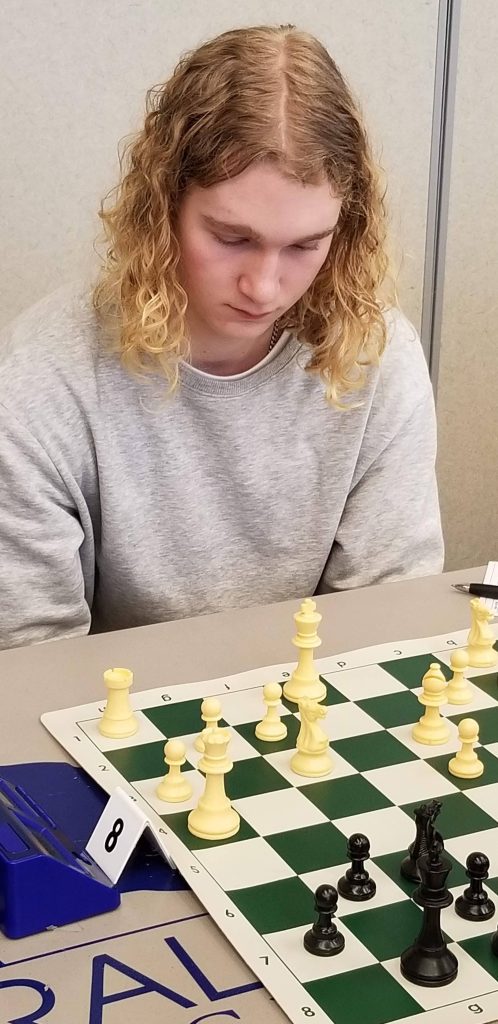 Chess champion Addison Flora sitting at a chess game