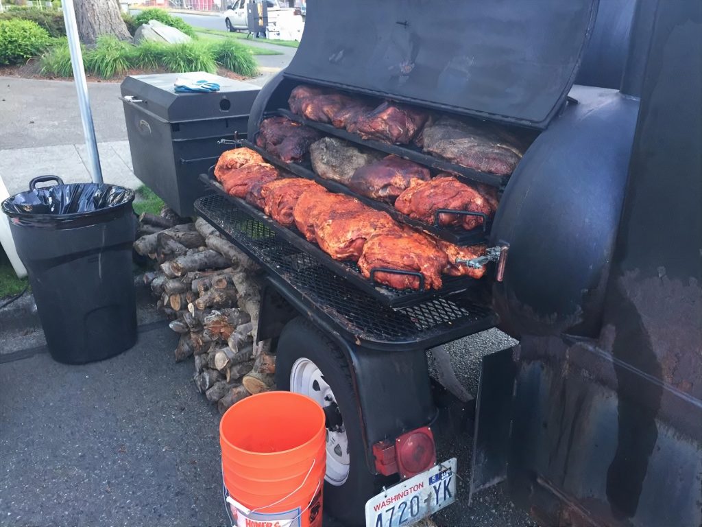 large barbecue grill piled high with meat