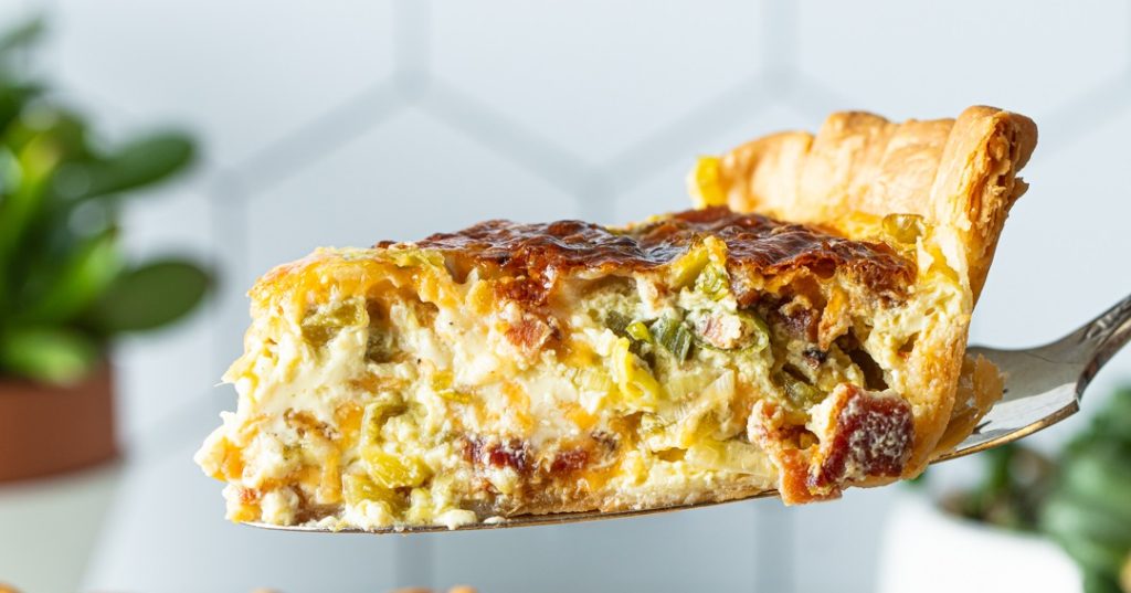 a slice of quiche on a serving tool