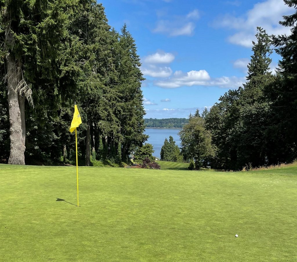 Olympia Country and Golf Club golf course with a yellow flag at the hole