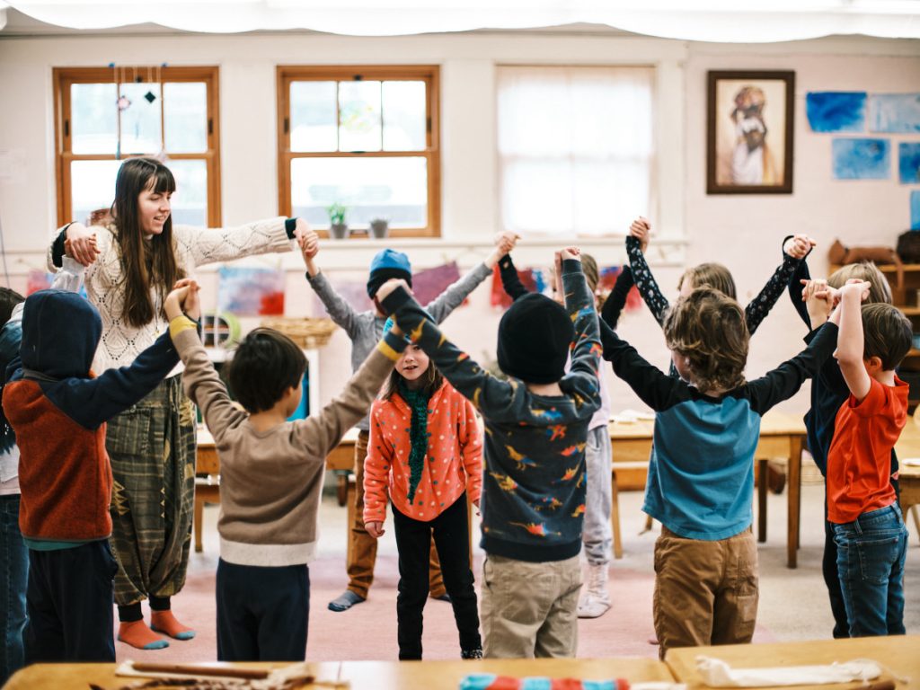 Kids doing a teacher-led group stretch