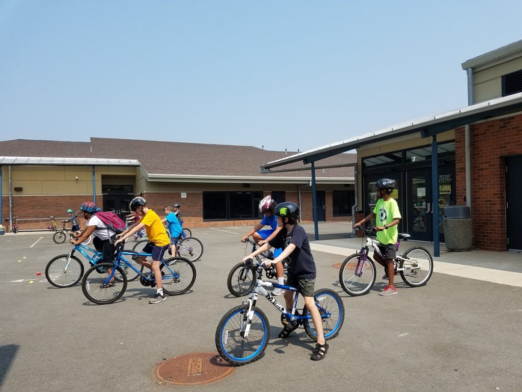 kids on bicycles at a parking lot