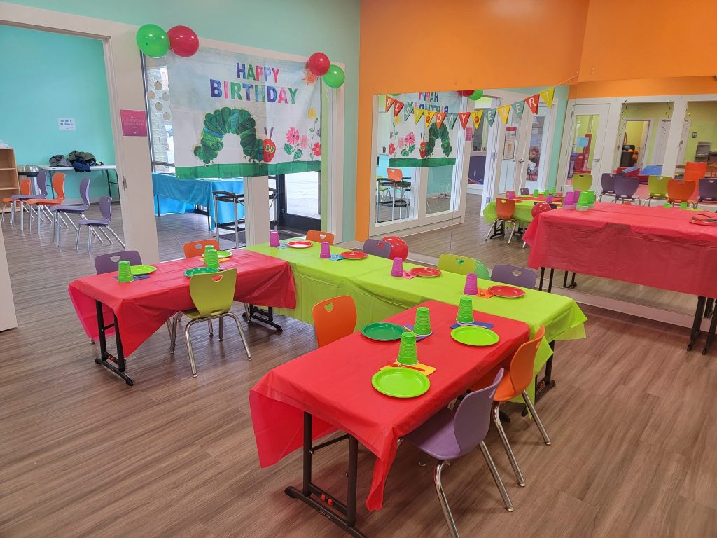party room at The Little Gym Olympia with tables set in red and green party decorations