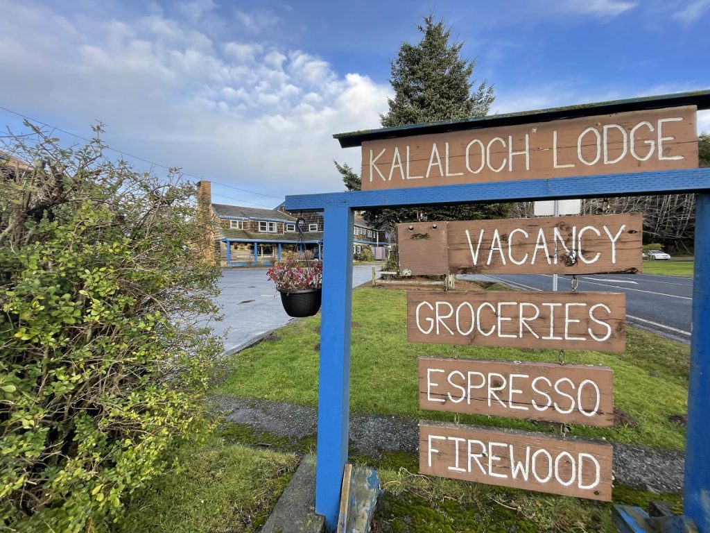 The Kalaloch Lodge sign with water and green grass in the background