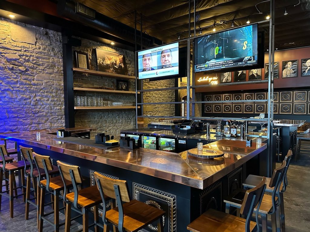 bar tables and chairs with two big screen TVs at 1779 Tenino Bar