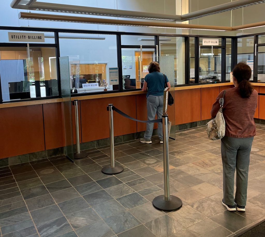 two people standing in line at a counter