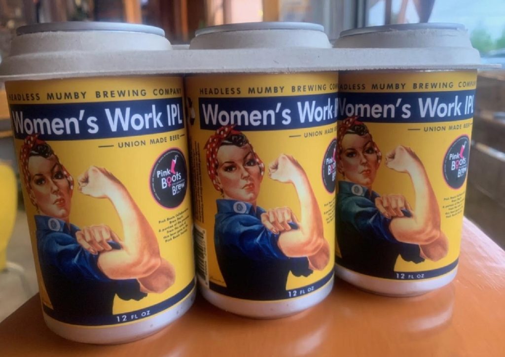 Three yellow cans with a women flexing her arm with the words, 'Women's Work IPL'