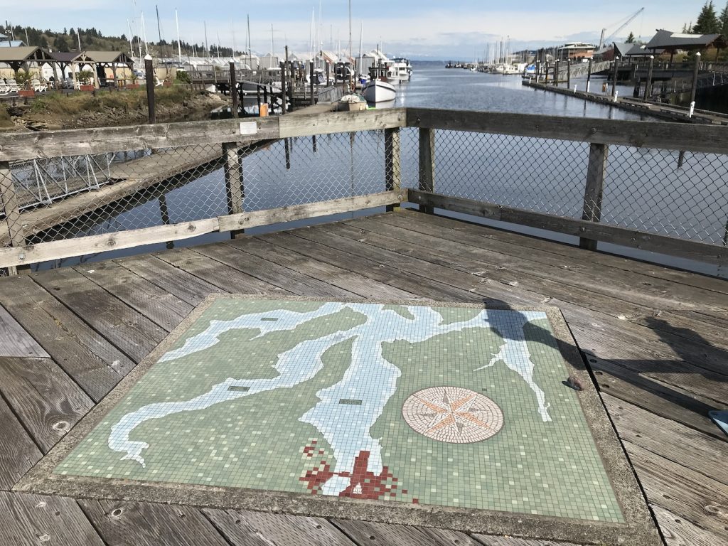 a mosaic map of the Budd Bay inlaid into a wooden dock in Olympia