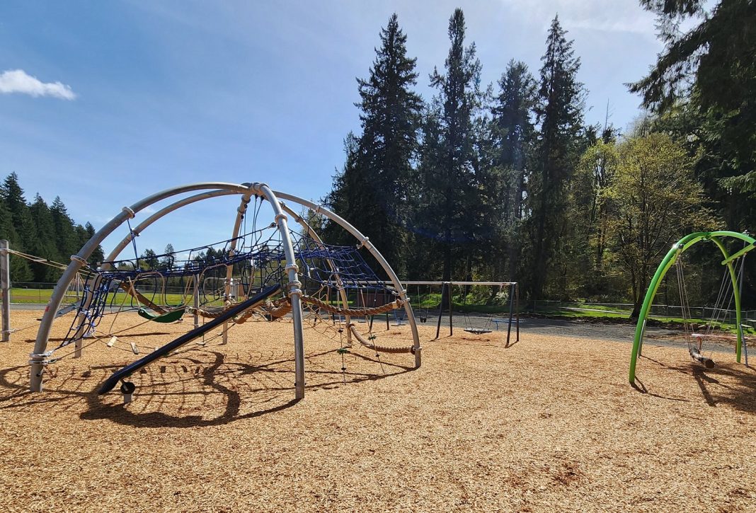 Tenino playground with slides, swings, monkey bars and more in bark mulch