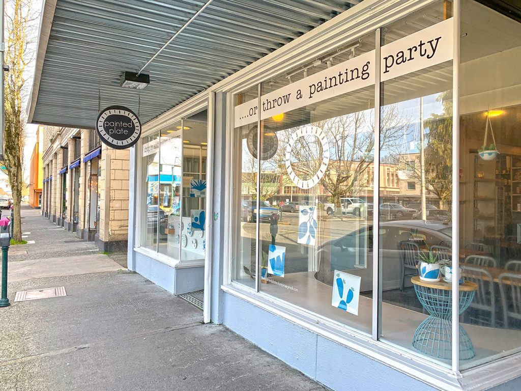 Painted plate shop window with a potted plant