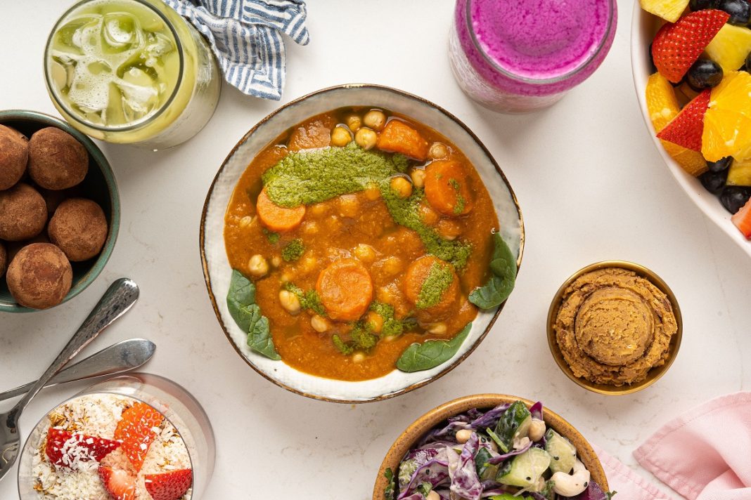 white table with bowls of different plant-based foods on it.