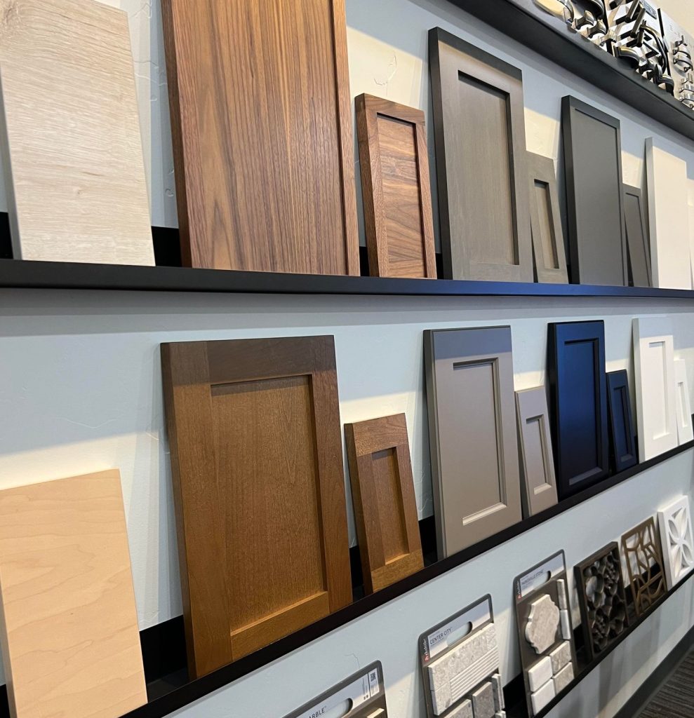 tile and cabinet wood samples on small shelves on a wall