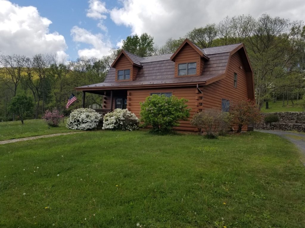 log cabin in grass