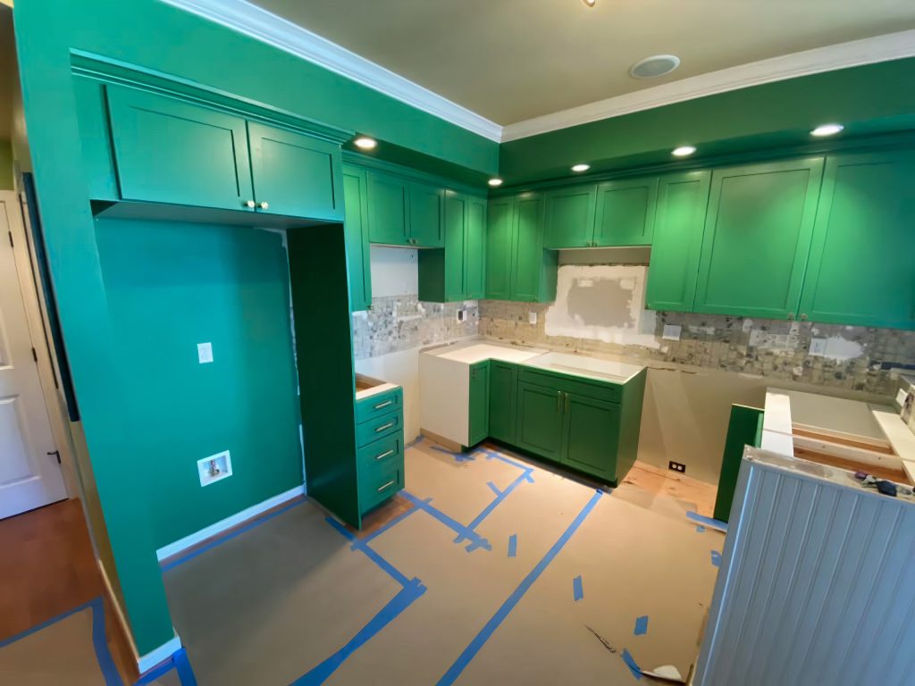 green kitchen with tape on floor outlining new flooring