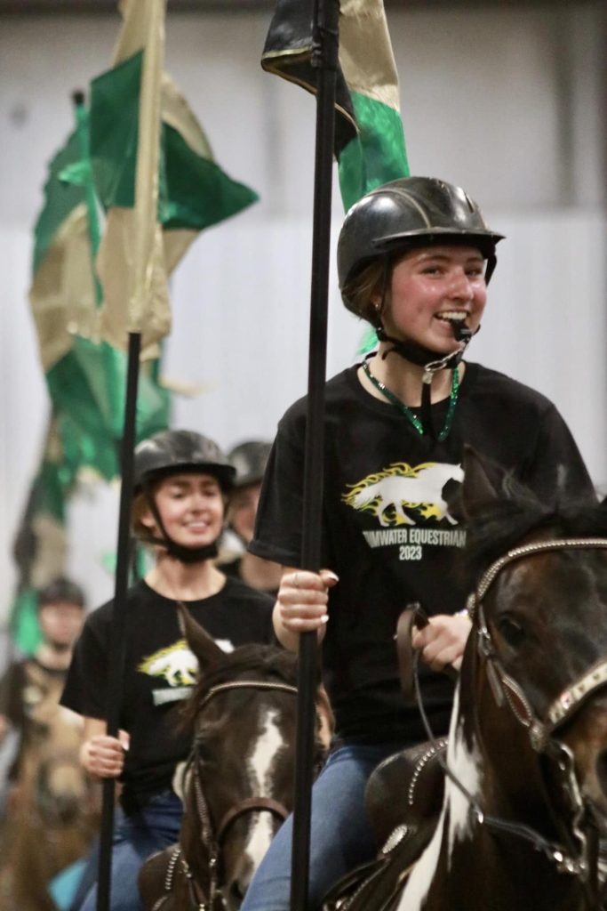 Kendra Stafford on her horse in the drill line, whistle in her mouth