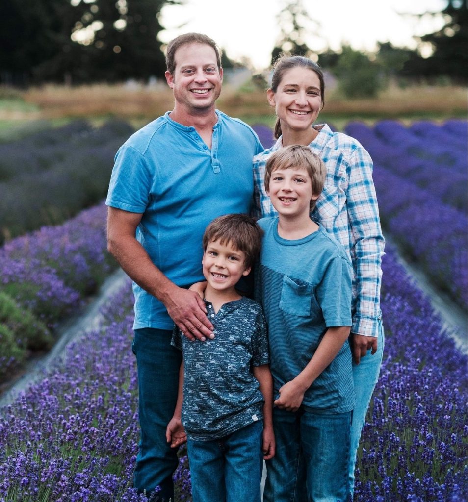 the Haight family sanding with their two sons in front of the parents in the lavender field