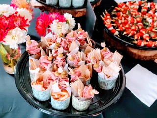 close up of appetizers on a black stand on a table