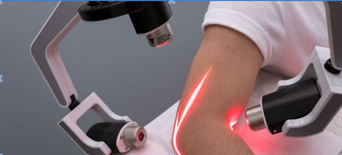 close up of an elbow getting cold laser treatment