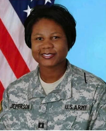  Angela Jefferson headshot wearing fatigues in front of an American Flag