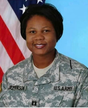 Angela Jefferson headshot wearing fatigues in front of an American Flag