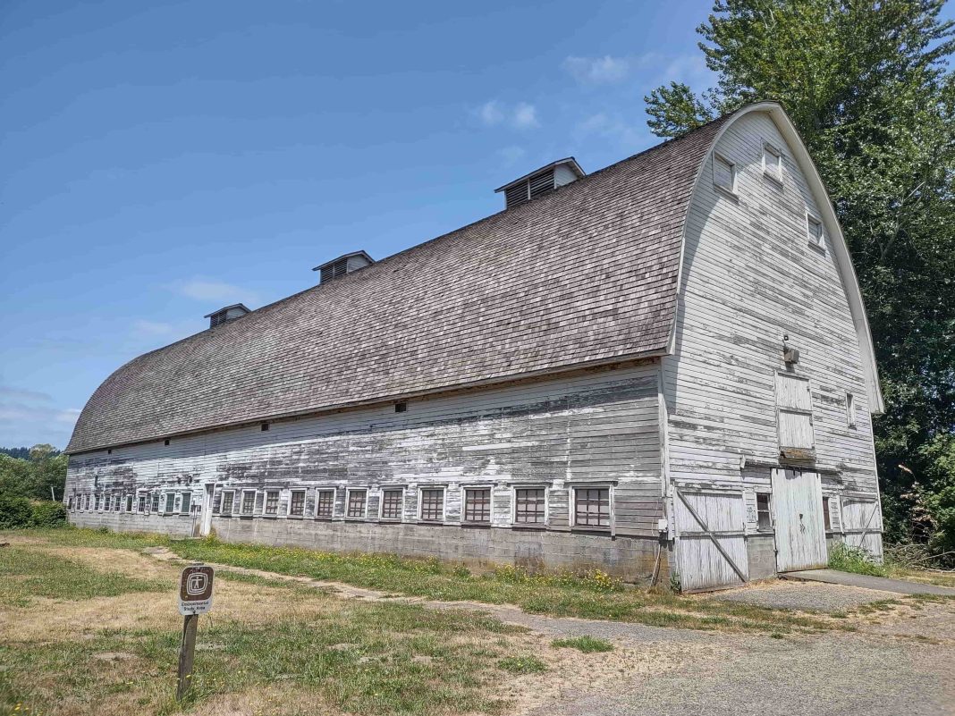 large, wood barn turned grey with age, in a field at Nisqually Wildlife Refuge
