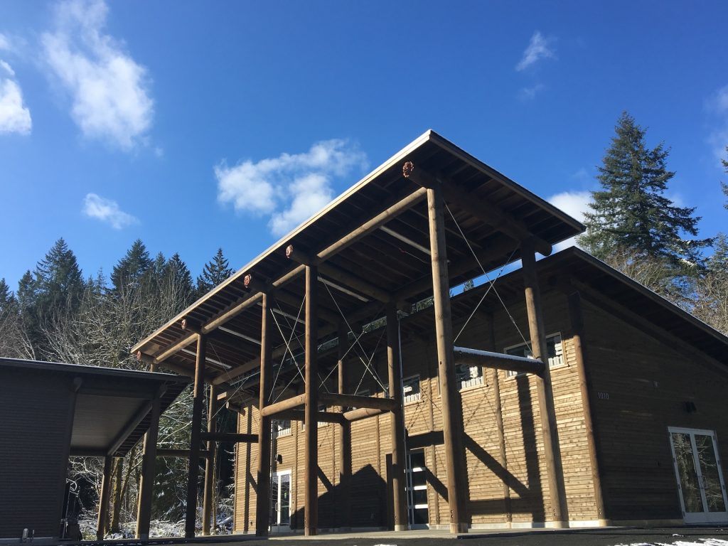 wooden building with trees around it