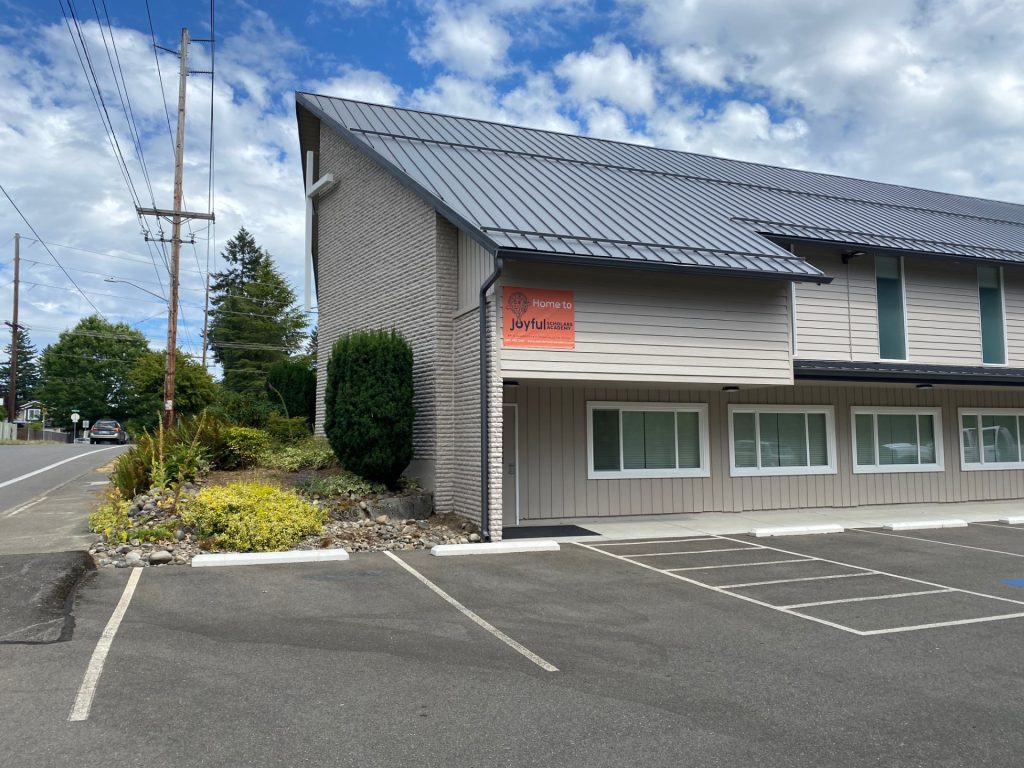 Hidden Creek Community Church building from the outside with trees and a parking lot