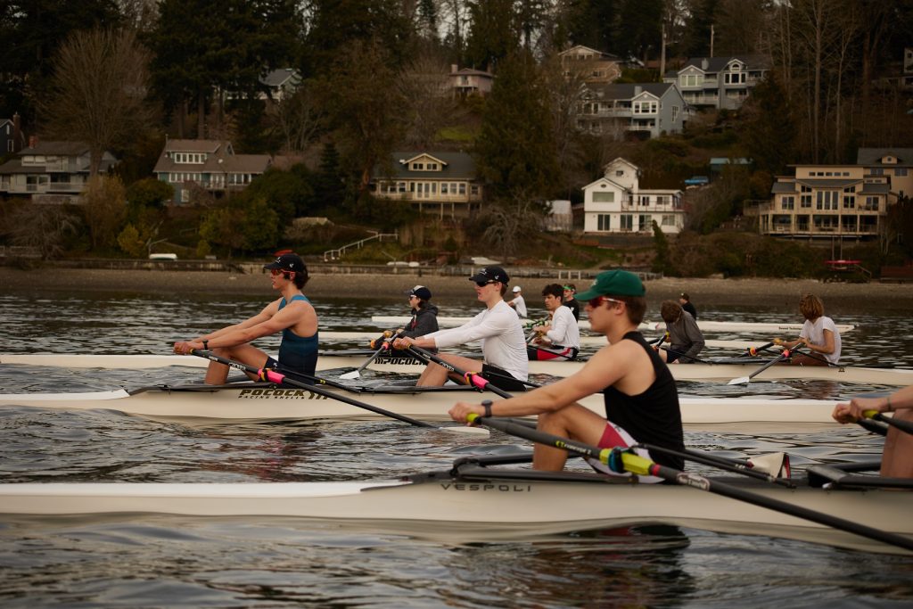 four row boats in a rowing race