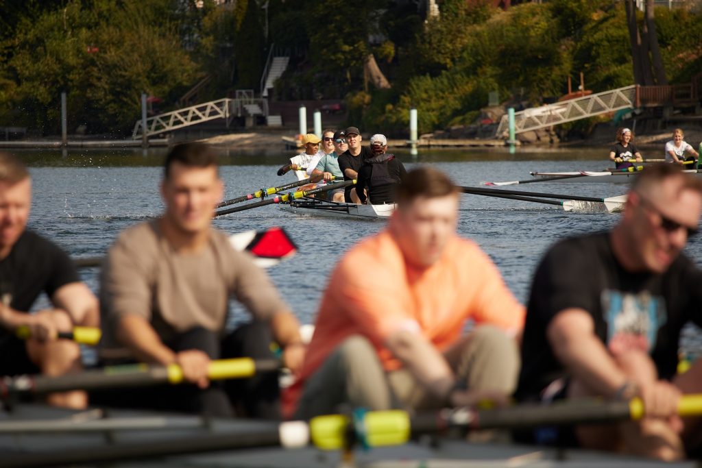 Four young men rowing in a row boat