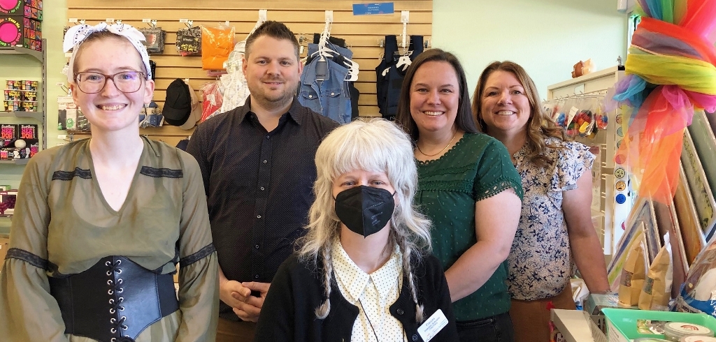 The staff at Sensory Tool House posing for a photo, one with a mask