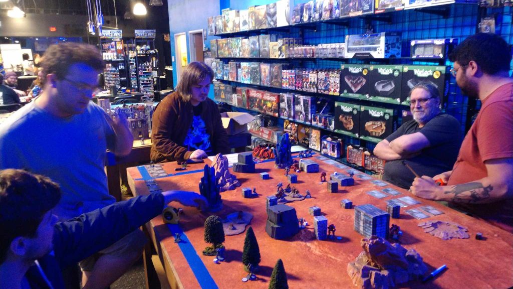Five people playing a large table top game at PLAYlive Nation/Forever Knight Games