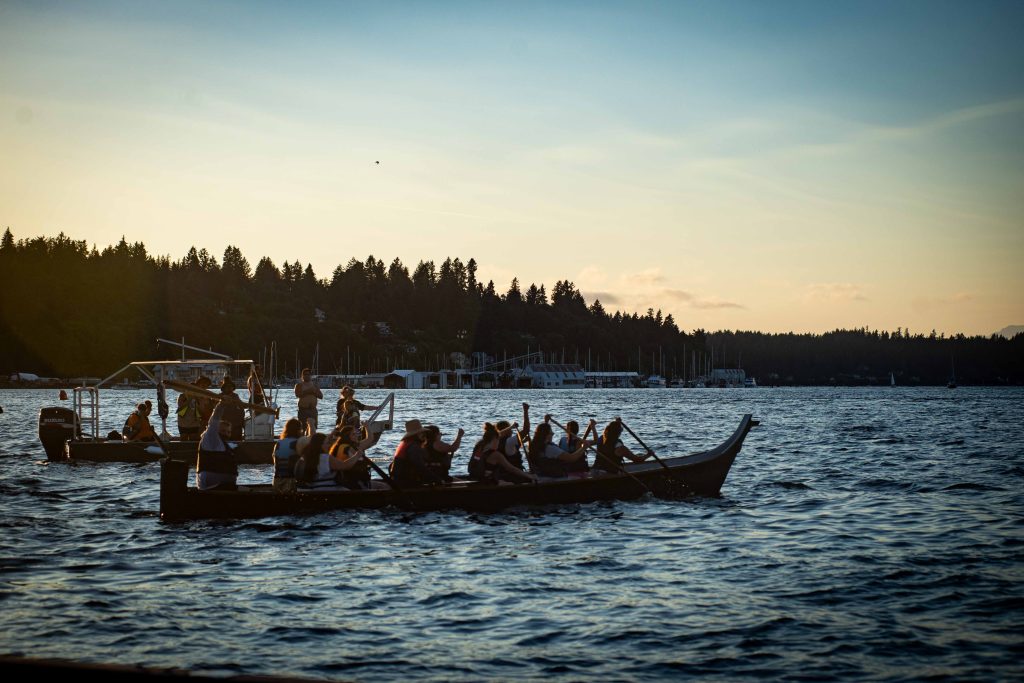 Squaxin Island Tribal members in canoes on the puget sound